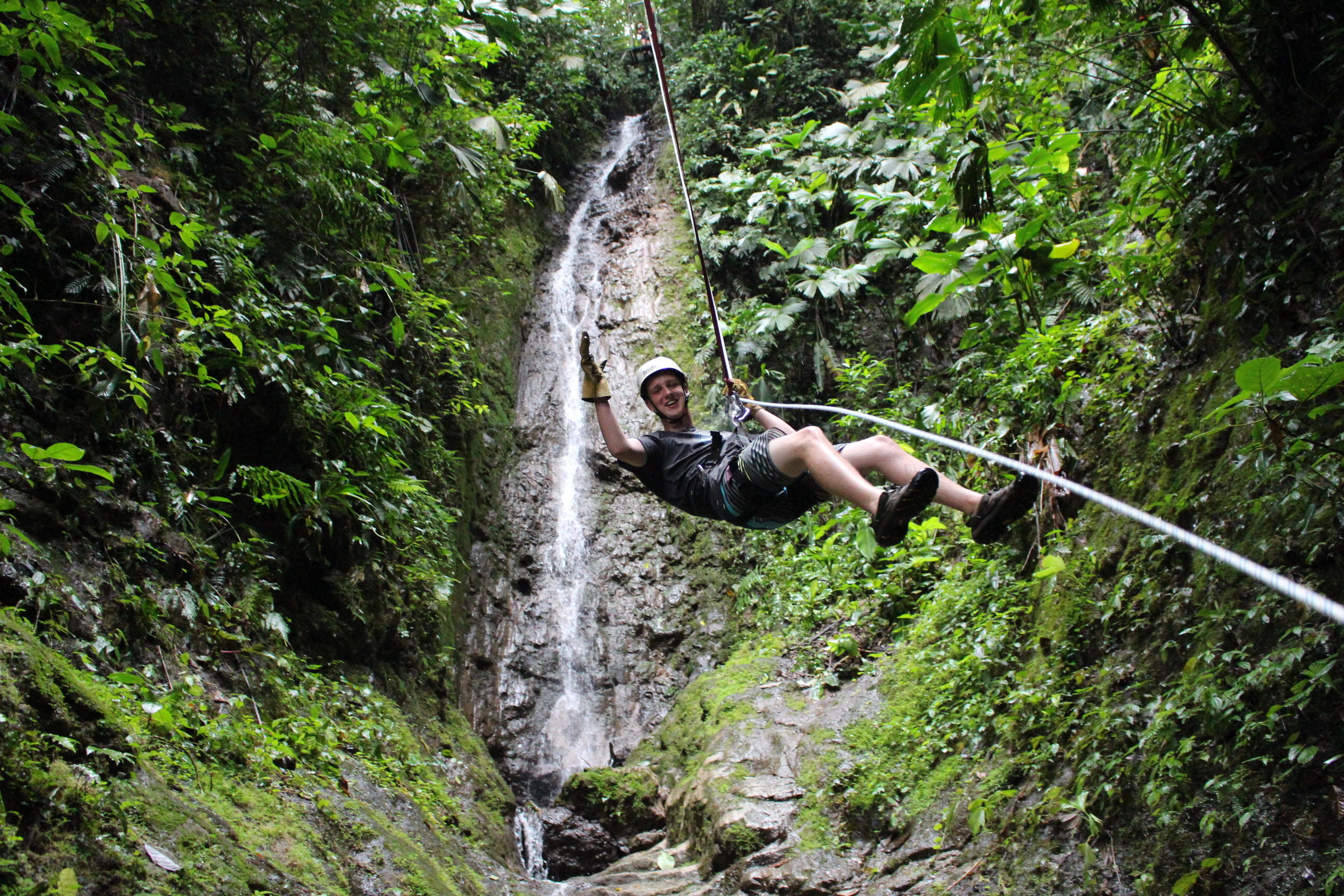 Garrett rapelling down a waterfall in Costa Rica.